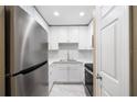 Cozy kitchen with stainless steel appliances, white cabinets, and marble floors at 1200 N Shore Ne Dr # 109, St Petersburg, FL 33701