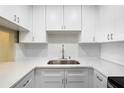 Kitchen sink with white cabinets and countertops at 1200 N Shore Ne Dr # 109, St Petersburg, FL 33701