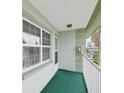 Condo balcony features tile flooring, a railing, and a view of the surrounding neighborhood at 1433 S Belcher Rd # F20, Clearwater, FL 33764