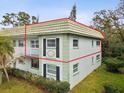 Corner view of condominium featuring tidy landscaping, ample natural light, and a light color scheme at 1433 S Belcher Rd # F20, Clearwater, FL 33764