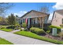 Charming single-story home with a well-manicured lawn and a brick walkway to the front door at 2845 Murray Pass, Odessa, FL 33556