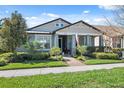 Charming single-story home with well-manicured lawn, front porch and a walkway to the front door at 2845 Murray Pass, Odessa, FL 33556