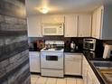 Functional kitchen featuring white appliances and cabinets, and a modern countertop at 2944 W Bay Dr # 104, Belleair Bluffs, FL 33770