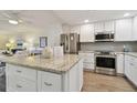 Open-concept kitchen featuring granite countertops and stainless steel appliances, seamlessly connected to the dining area at 3717 46Th S Ave # 7, St Petersburg, FL 33711