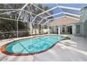 Relaxing kidney-shaped pool set within a screened enclosure, providing a perfect outdoor retreat at 4442 Clairson Ct, Palm Harbor, FL 34685