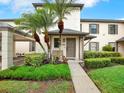 View of the front yard featuring lush landscaping and palm trees at 4524 Southampton Ct # 4524, Tampa, FL 33618