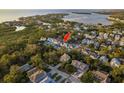 Aerial view of a neighborhood with stunning water views and mature landscaping at 476 Rebstock Blvd, Palm Harbor, FL 34683