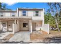 Attractive townhome featuring a private courtyard, neutral colors and traditional shutters at 5225 Tennis Court Cir # 5225, Tampa, FL 33617