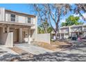 Inviting townhome showcasing a courtyard, neutral tones and mature trees at 5225 Tennis Court Cir # 5225, Tampa, FL 33617