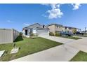 Street view of house featuring a well-manicured lawn and driveway at 5617 Flagstone Trl, Palmetto, FL 34221