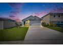 Exterior shot of the house as dusk approaches at 5617 Flagstone Trl, Palmetto, FL 34221