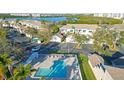 Aerial view of community pool with lounge chairs, umbrellas, and well-maintained surroundings at 6401 99Th N Way # 15C, St Petersburg, FL 33708