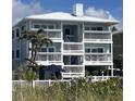 Three-story beach house with white railings, balconies and beautiful views of the ocean at 712 Beach Trl # C, Indian Rocks Beach, FL 33785