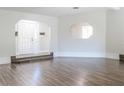 Spacious living room showcasing hardwood floors, archway, and bright natural light at 8436 Cameo St, Spring Hill, FL 34608
