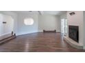 Open-concept living area with hardwood floors, fireplace, and unique architectural details at 8436 Cameo St, Spring Hill, FL 34608