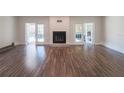 Bright living room with hardwood floors, fireplace, and french doors leading to backyard at 8436 Cameo St, Spring Hill, FL 34608