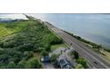 Beautiful aerial view of the property's proximity to the waterfront and surrounding greenery at 14 Seagrape Cir, Clearwater, FL 33759