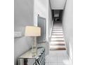Bright staircase with white risers and wooden treads, complemented by modern decor and light gray walls at 14 Seagrape Cir, Clearwater, FL 33759