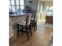 Kitchen bar with stone accents, comfortable bar stools, and hardwood floors for a stylish culinary space at 16103 4Th E St, Redington Beach, FL 33708