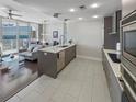 Contemporary open kitchen with island and bar seating flowing into living area and dark accents at 175 1St S St # 1204, St Petersburg, FL 33701