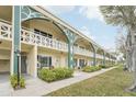 Inviting condo complex with manicured lawns, pedestrian walkways, and classic architectural design at 2400 Franciscan Dr # 34, Clearwater, FL 33763