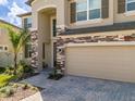 Charming home featuring a multi-car garage and inviting front entrance at 3150 Marine Grass Dr, Wimauma, FL 33598