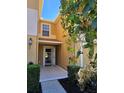 Inviting home entrance with tiled porch, complemented by manicured bushes and vibrant foliage at 4224 Winding River Way, Land O Lakes, FL 34639