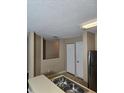Kitchen showcasing stainless steel appliances, a double sink, and easy access to other living spaces at 4224 Winding River Way, Land O Lakes, FL 34639