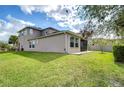 Spacious backyard with a screened lanai and ample green space, perfect for outdoor enjoyment at 4627 Tramanto Ln, Wesley Chapel, FL 33543