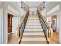 Beautiful staircase with wood treads and decorative railings, bathed in natural light, creates a grand entrance at 4707 Troydale Rd, Tampa, FL 33615