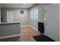 Bright dining area with luxury vinyl plank flooring and a modern entryway at 4930 S 82Nd St, Tampa, FL 33619