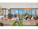 Bright living room showcasing floor-to-ceiling windows with a stunning view of the intercoastal waterway and comfortable seating at 5950 Pelican Bay S Plz # Ph-2F, Gulfport, FL 33707
