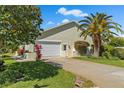Charming home features a well-manicured lawn, attached garage and a classic driveway at 725 Monte Cristo Blvd, Tierra Verde, FL 33715