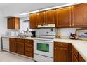 Bright kitchen features wooden cabinets, white appliances, and ample countertop space at 808 Bahia Del Sol Dr # 14, Ruskin, FL 33570