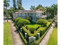 Beautifully landscaped property featuring mature trees and manicured hedges surrounding this amazing two-story home at 1311 Beach Ne Dr, St Petersburg, FL 33701