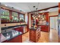 A well-appointed kitchen with cherry cabinets, granite countertops, and stainless-steel appliances offers a luxurious cooking space at 1311 Beach Ne Dr, St Petersburg, FL 33701