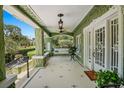 Charming porch with white tile flooring, ceiling fans, and cozy swing for relaxing at 1311 Beach Ne Dr, St Petersburg, FL 33701