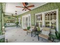 Inviting porch with comfortable seating, ceiling fans, and views of the well-maintained landscaping at 1311 Beach Ne Dr, St Petersburg, FL 33701