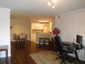 Open living space with hardwood floors, seamlessly connecting the kitchen and dining area, with ample natural light at 18106 Peregrines Perch Pl # 5208, Lutz, FL 33558