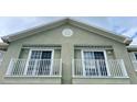Balconies featuring white railings and adjacent windows on an exterior facade at 27901 Pleasure Ride Loop, Wesley Chapel, FL 33544