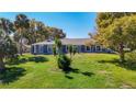 Beautiful one-story home with lush green lawn, mature trees, and inviting curb appeal at 5253 Sandra Dr, Weeki Wachee, FL 34607
