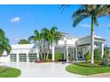Magnificent two-story home featuring a three-car garage, manicured lawns, and a bright-white driveway at 866 S Davis Blvd, Tampa, FL 33606