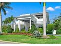 Elegant two-story home featuring a grand entrance, beautiful columns, and carefully trimmed landscaping at 866 S Davis Blvd, Tampa, FL 33606