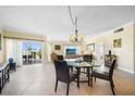 Bright living and dining area with sliding glass doors leading to a balcony at 1200 N Shore Ne Dr # 110, St Petersburg, FL 33701