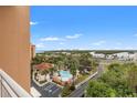 Balcony view of the community pool with palm trees and picturesque waterfront views at 12033 Gandy N Blvd # 175, St Petersburg, FL 33702