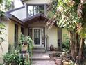 Inviting home entrance with a decorative glass door and verdant landscaping at 16921 Crawley Rd, Odessa, FL 33556