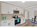 Modern kitchen boasts stainless steel appliances, white cabinets, and ample countertop space at 1910 E Chelsea St, Tampa, FL 33610