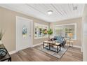 Cozy living room featuring wood-look floors, a large window, and comfortable seating at 1910 E Chelsea St, Tampa, FL 33610