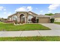 Attractive single-story home with manicured lawn and a two-car garage at 2015 Golf Manor Blvd, Valrico, FL 33596