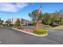 Community entrance with signage, landscaping, and carports at 210 Fernwood Cir # 210, Seminole, FL 33777